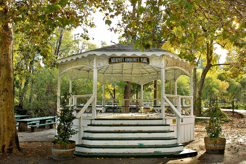 A white gazebo in Murphy's Community Park surrounded by trees.